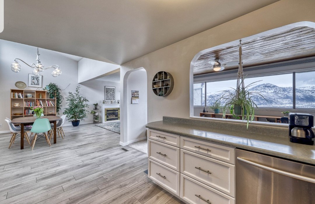 Beautiful interior of a Kamloops house for sale with a bright, open-concept kitchen and living space and mountain views
