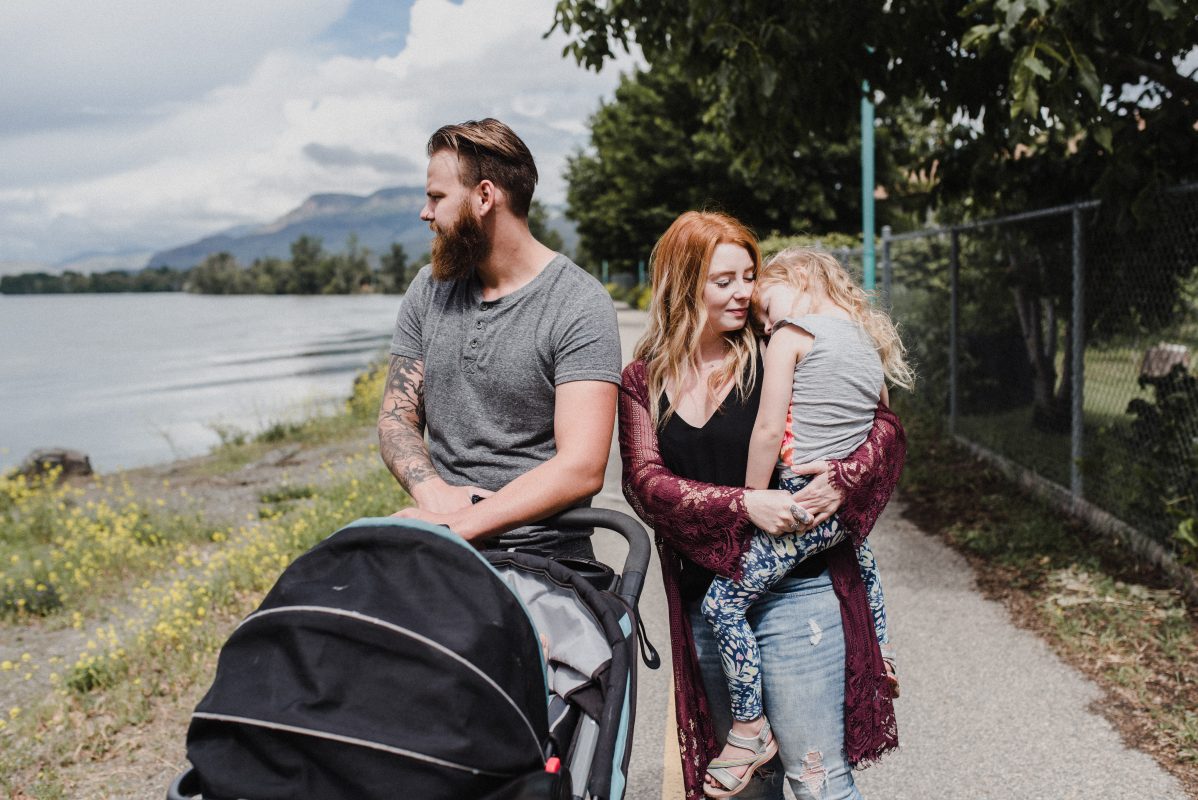Skyleigh McCallum Financial Educator walks in a park with her family in Kamloops
