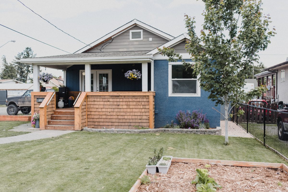 Blue character home in Kamloops with wood porch, tips to reduce stress when buying a home in Kamloops