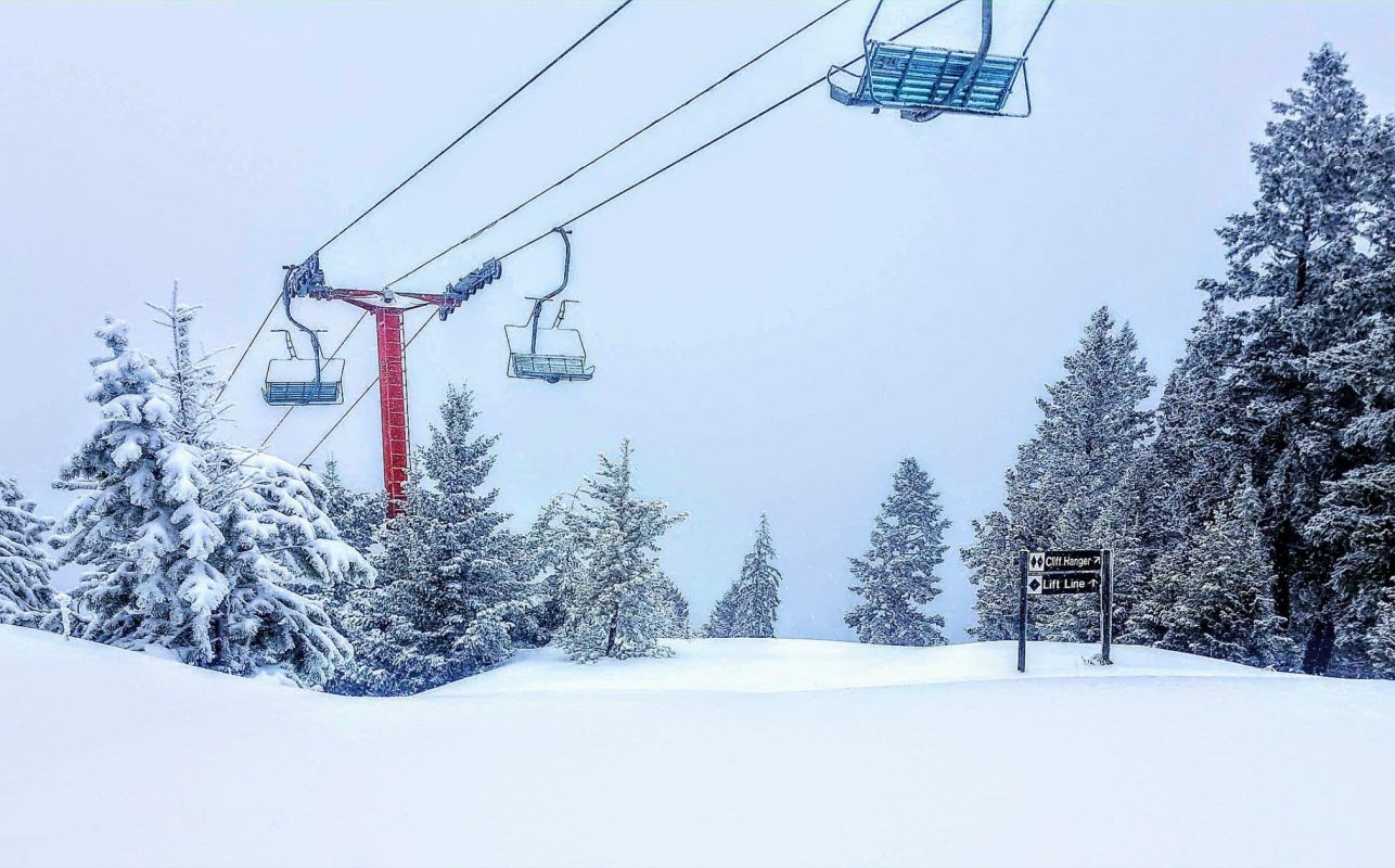 Snowy trees and a chairlift at Harper Mountain, a fun activity in Kamloops for families.