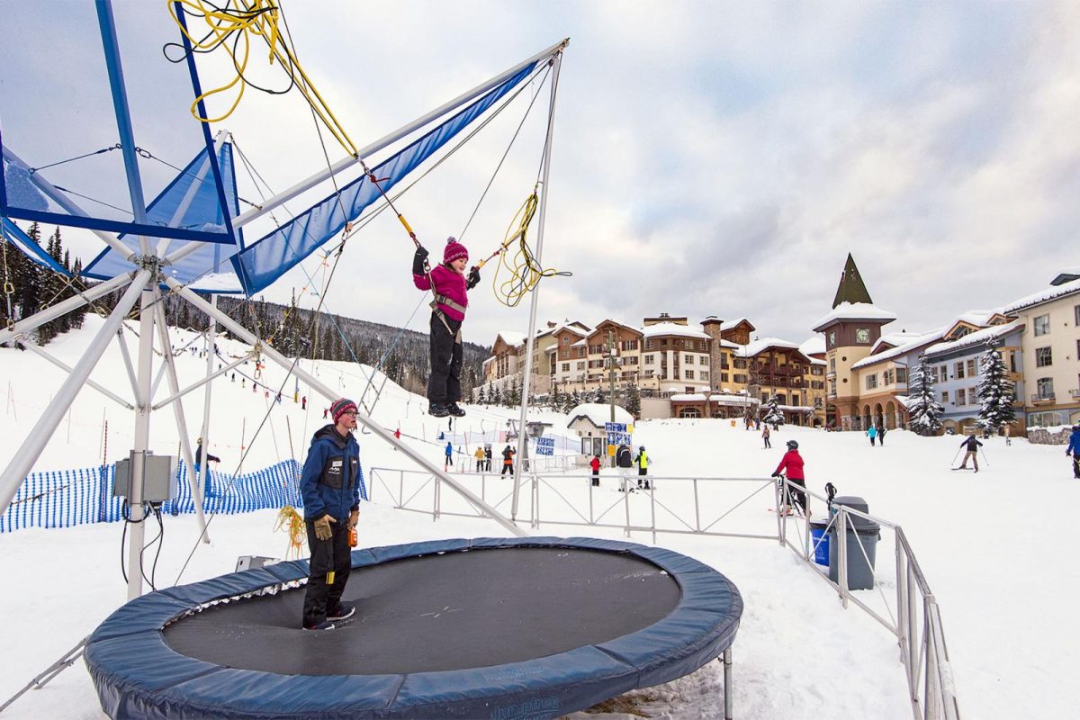 A child playing on the trampoline during the winter at Sun Peaks Resort near Kamloops, BC.