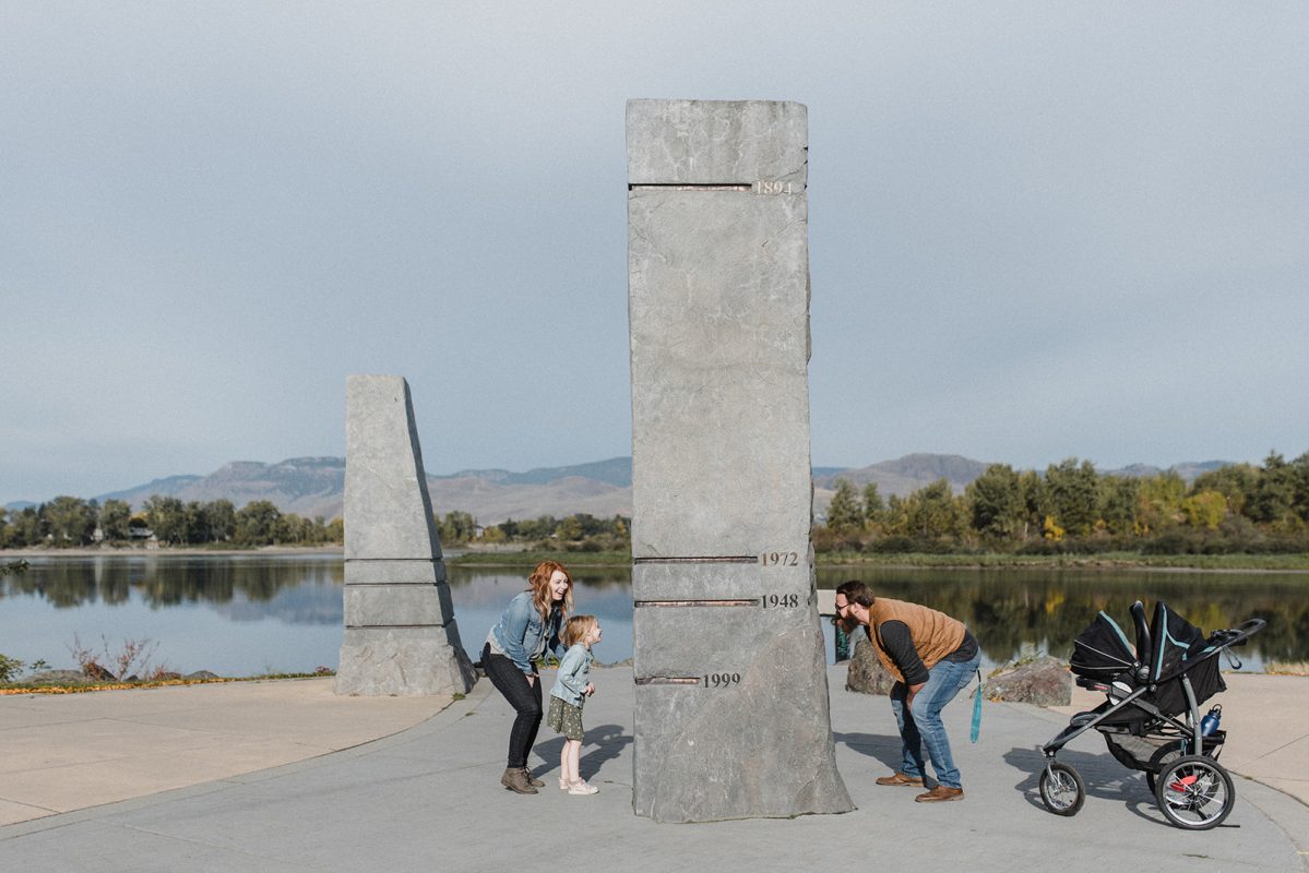 A Kamloops family of four standing at a structure that shows past water levels in Riverside Park in downtown Kamloops.