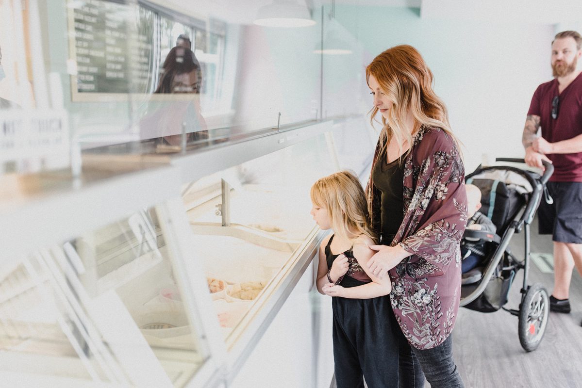 A family placing their order at a cute ice cream shop called Scoops Ice Cream in downtown Kamloops.