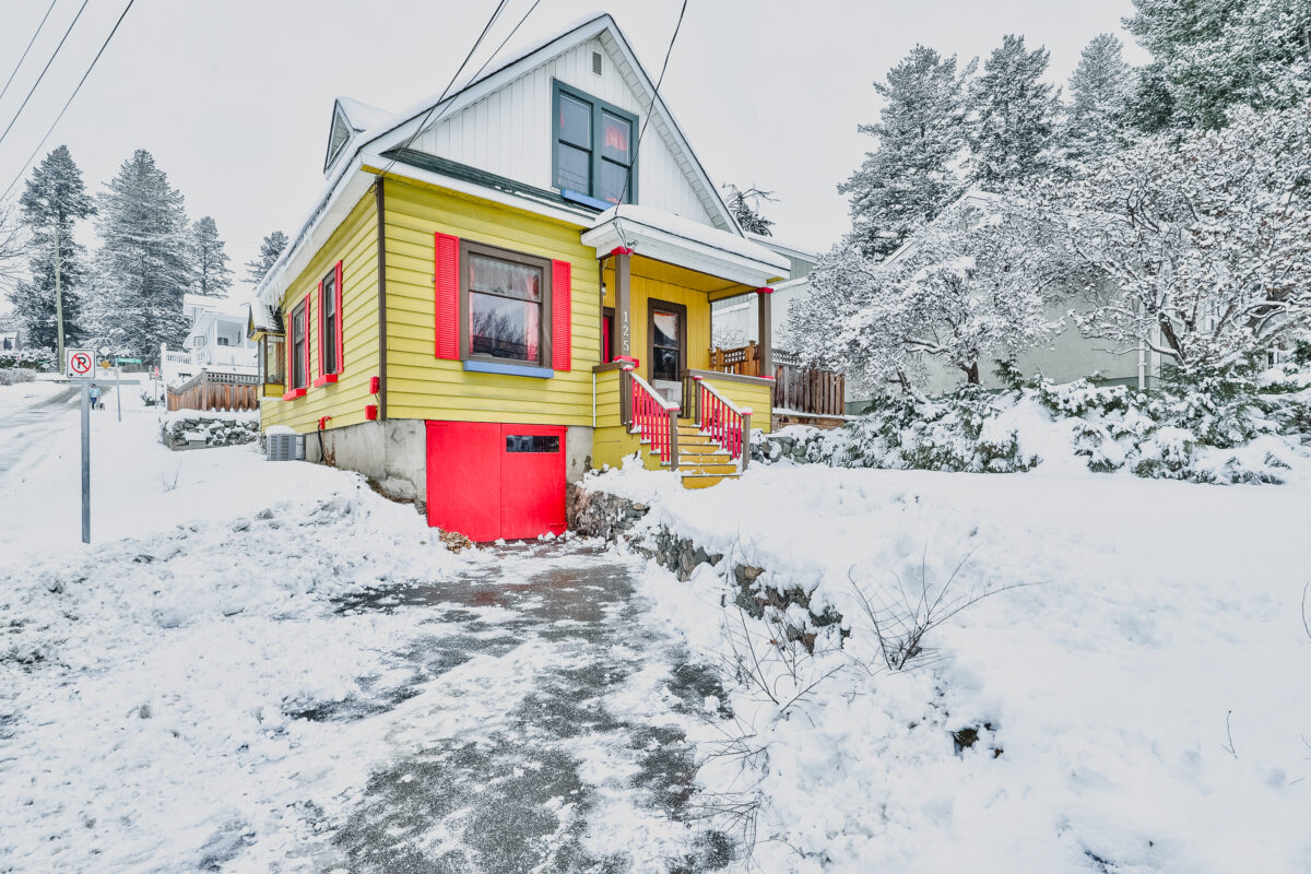 A cute yellow character home with red trim that was recently sold in the Kamloops real estate market.