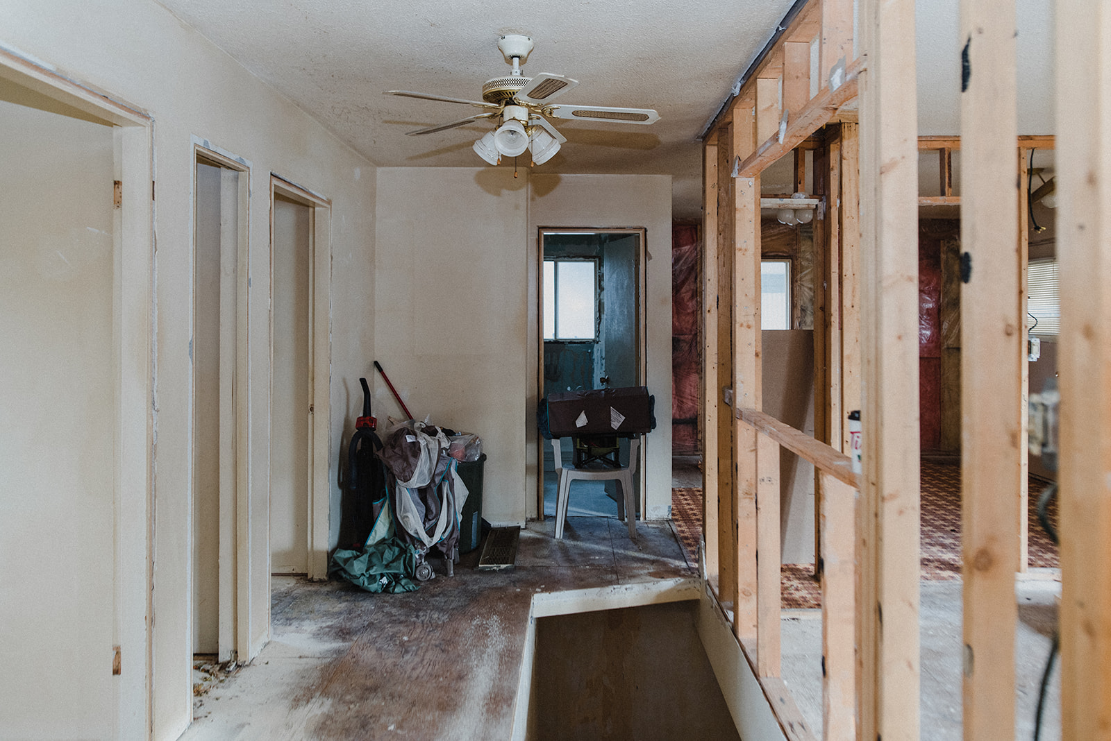 The interior of a house where the family decided to live in the home while renovating it, with missing walls and dust on tools laying around.