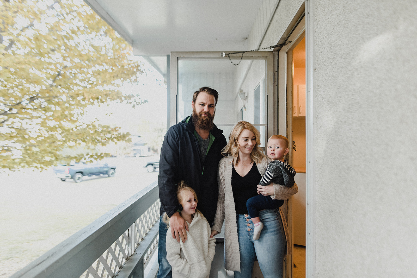 Kamloops Realtor Skyleigh McCallum stands with her family in the doorway of a home they recently purchased, debating the pros and cons of living in your renovation.