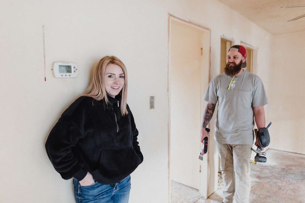 Skyleigh McCallum Kamloops Realtor and her husband stand in their renovation project home.