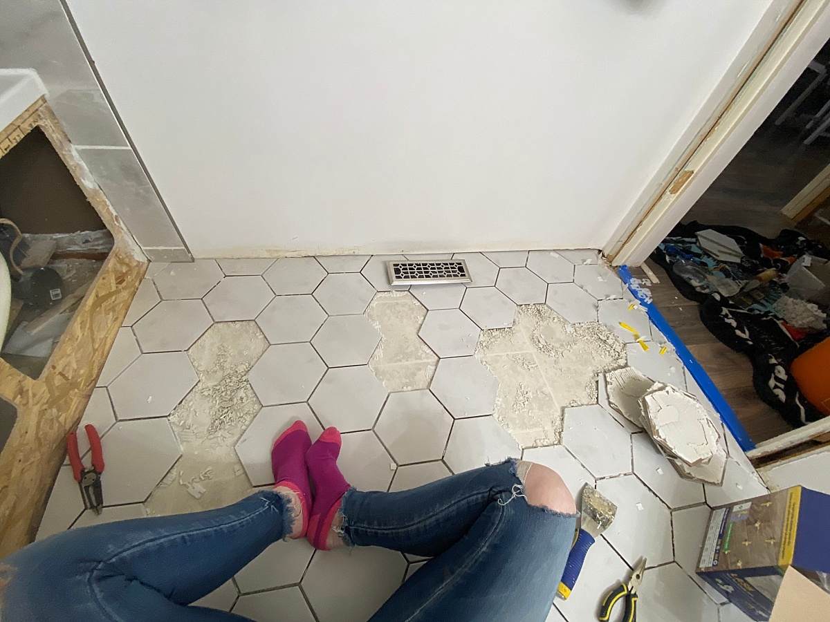 Bathroom floor tiling pulling off because the mortar wasn't done correctly; a common bathroom floor tiling mistake to avoid.