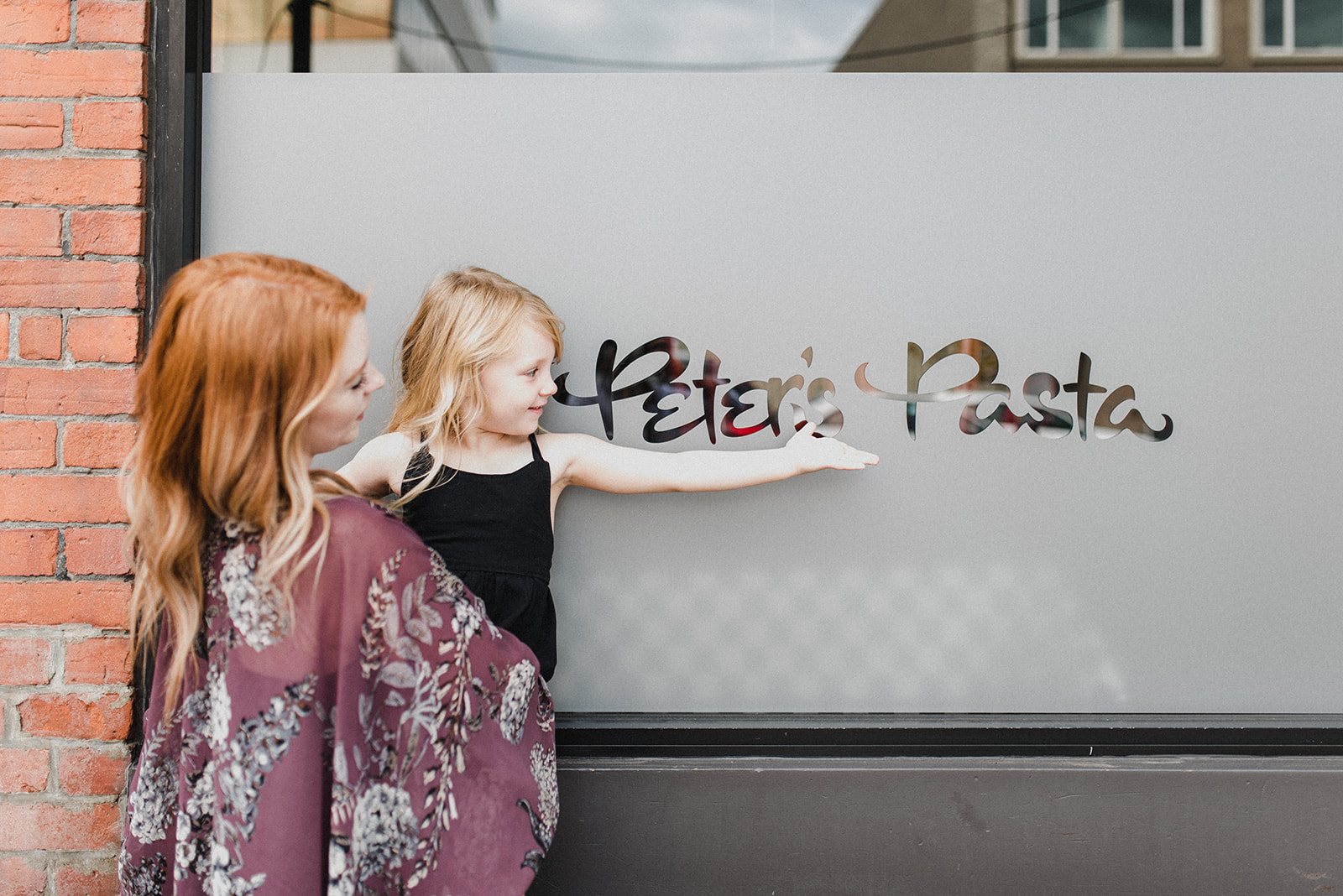 Skyleigh standing with her daughter in front of Peter's Pasta in Kamloops