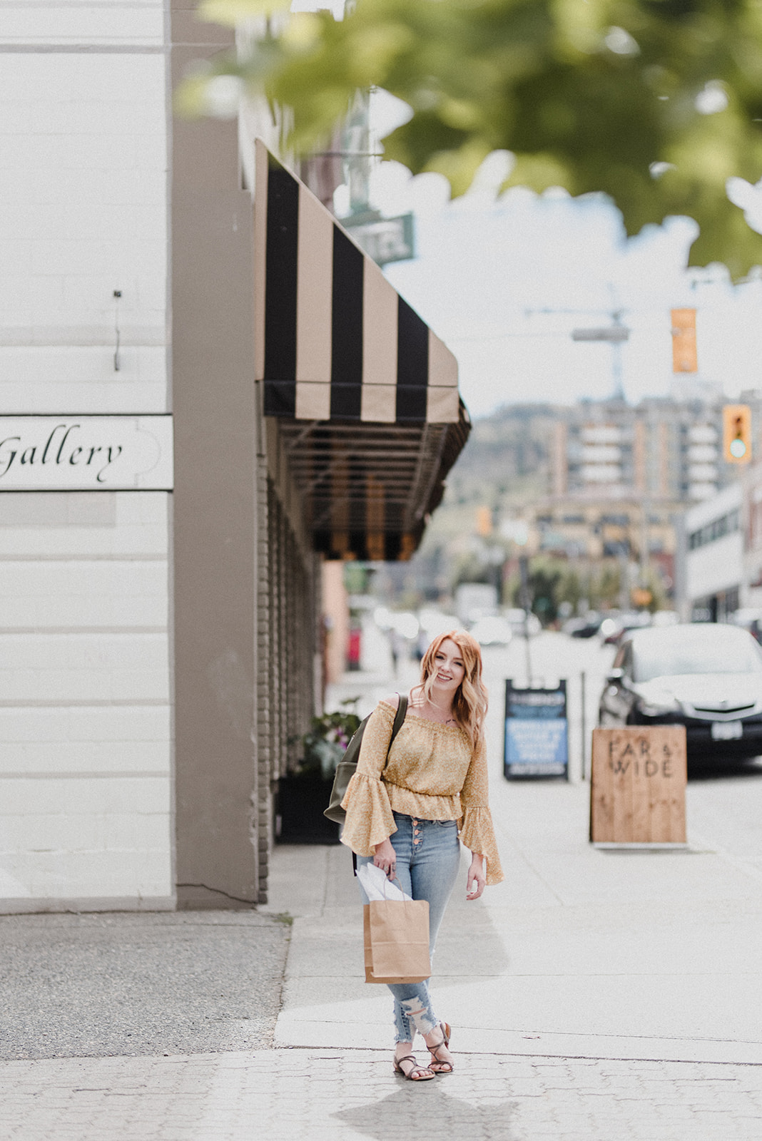 Skyleigh in a yellow top and jeans shopping in downtown Kamloops 